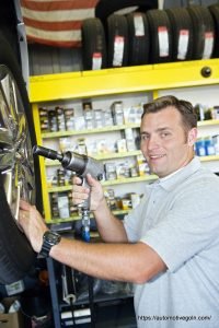 Automotive Gurukul : Mechanic repairing car on hydraulic platform